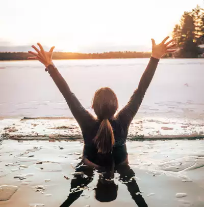 A woman takes a cold plunge at Dimensions Algonquin Highlands