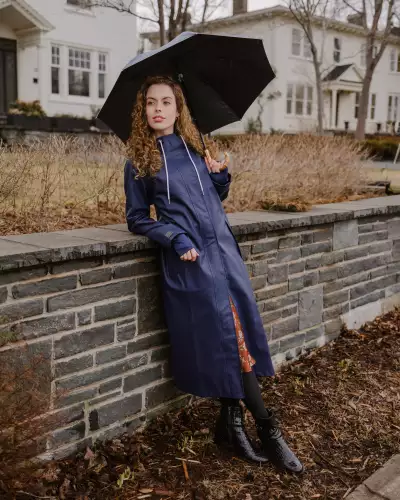 Someone wearing The Mernini raincoat in Midnight Blue