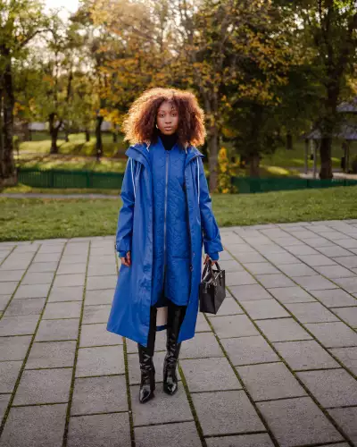 Someone wearing The Mernini raincoat in Peony Blue