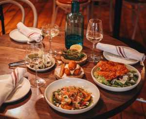Bocado in Picton | A spread of Spanish tapas dishes and wine on a table at Bocado