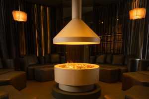 Trove Toronto | A firepit forms the centrepiece of the IV Therapy Lounge at Trove