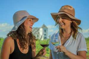 Two women sip wine at Closson Chase in Prince Edward County Two women sip wine at Closson Chase in Prince Edward County
