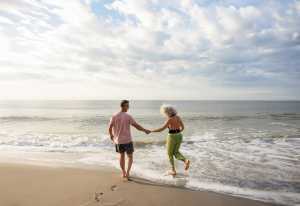 Myrtle Beach | A couple holds hands in the sea in Myrtle Beach