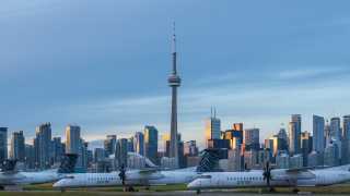 Airplanes at Billy Bishop Toronto City Airport with the city skyline as the backdrop