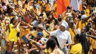 Barbados Rum and Food Festival | A sea of people dressed in yellow at the Rise and Rum Breakfast Beach Party