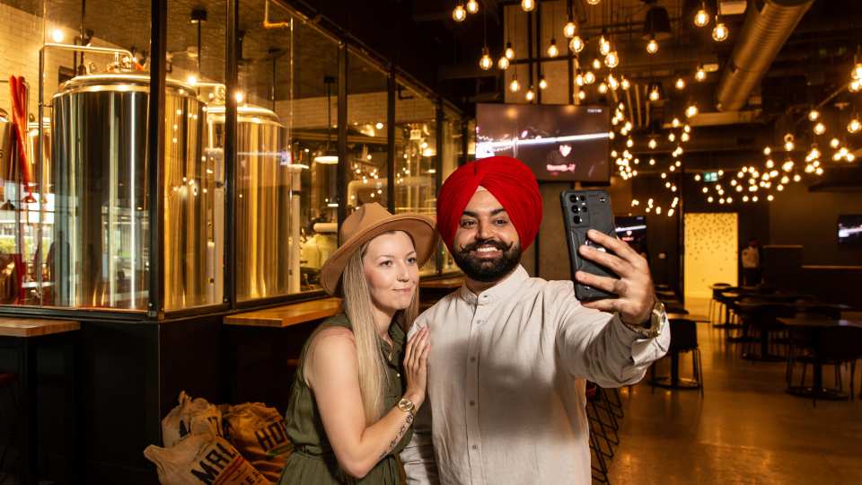 Manitoba restaurants | A couple takes a selfie at a brewery in Manitoba