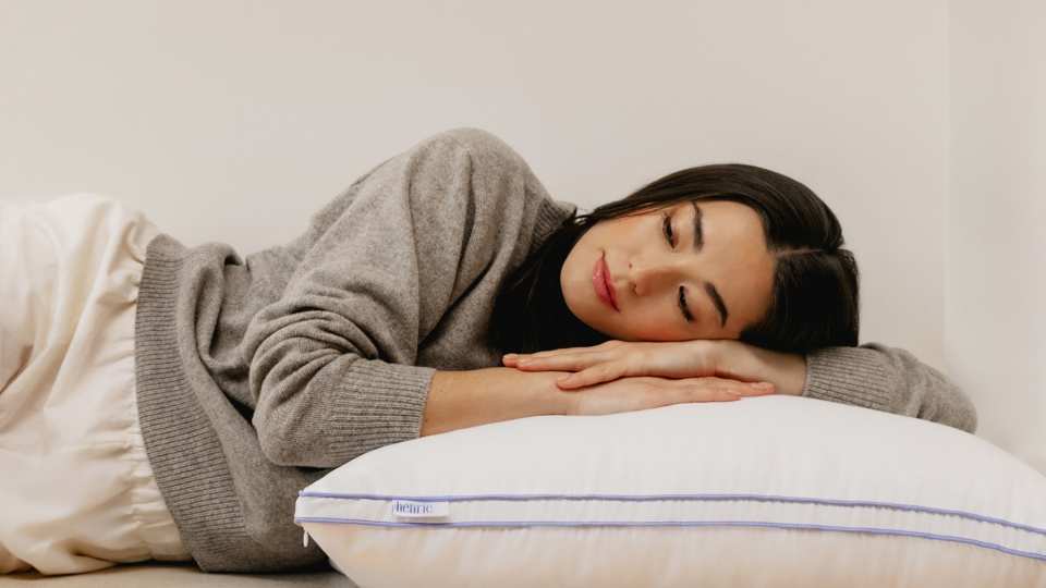 A woman sleeping on The Henrie Adjustable Pillow