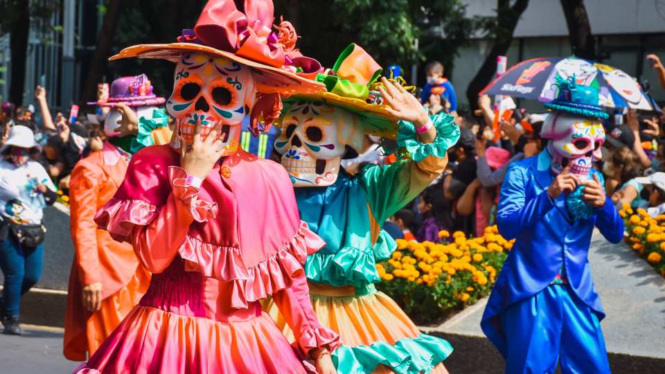 People dressed in costumes at the Día de los Muertos parade in Mexico City