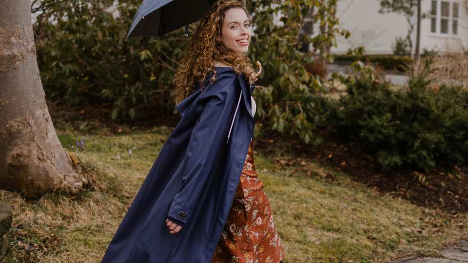 Someone wearing the Midnight Blue Mernini raincoat