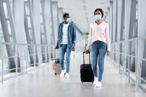 Travel tips | People walking through the airport with luggage