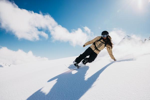 A snowboarder wearing the Men's Burton [ak] Swash GORE‑TEX 2L snowboarding jacket