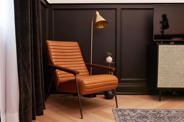 The Dorchester Hotel in Collingwood | A chair inside a guest room at The Dorchester Hotel