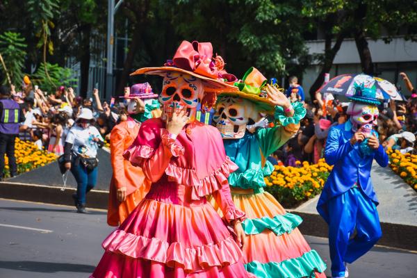 People dressed in costumes at the Día de los Muertos parade in Mexico City