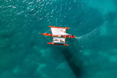 A Hawaiian canoe sails on the ocean