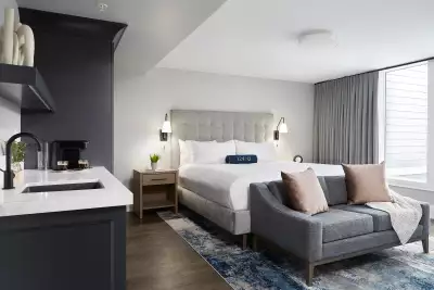 124 on Queen Hotel and Spa | A Signature Deluxe King guest room with a sofa and a kitchenette