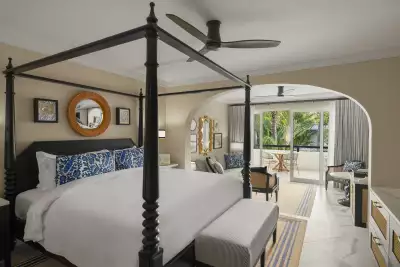 A king bed inside a hotel room at Colony Club, Barbados