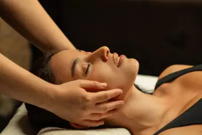 A guest receiving a face massage at Aire Ancient Baths Toronto