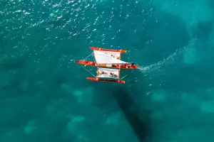 A Hawaiian canoe sails on the ocean