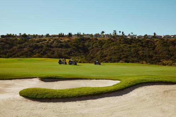 Golf carts drive along the course at Fairmont Grand Del Mar, San Diego Golf carts drive along the course at Fairmont Grand Del Mar, San Diego