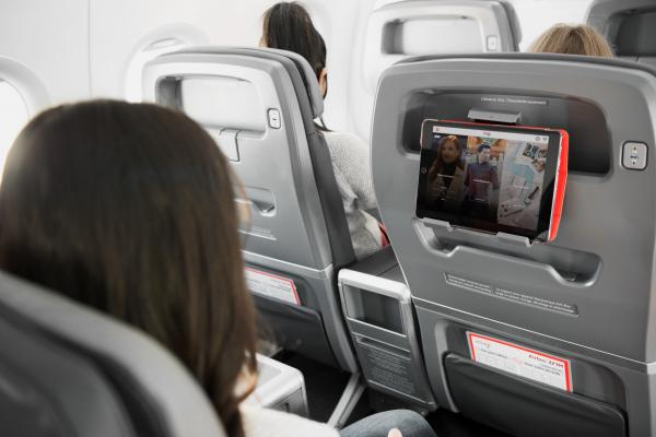 Travel tips | An Air Canada Rouge passenger watches a movie on her iPad Travel tips | An Air Canada Rouge passenger watches a movie on her iPad