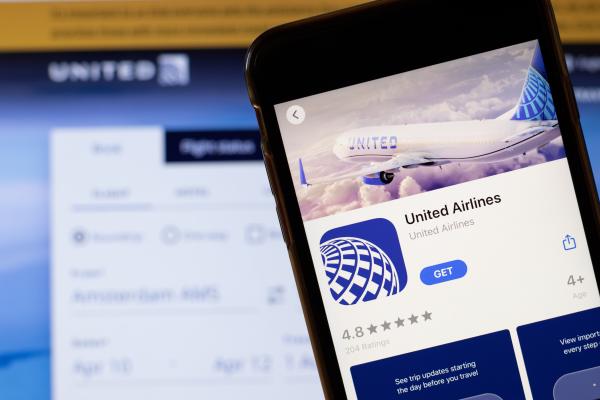 Travel tips | United Airlines app logo on phone screen Travel tips | United Airlines app logo on phone screen