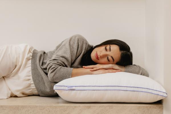 A woman sleeping on The Henrie Adjustable Pillow