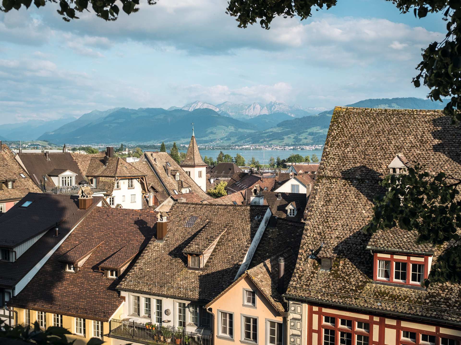 Switzerland Swiss Travel Pass | Houses and mountain in Rapperswil, Switzerland