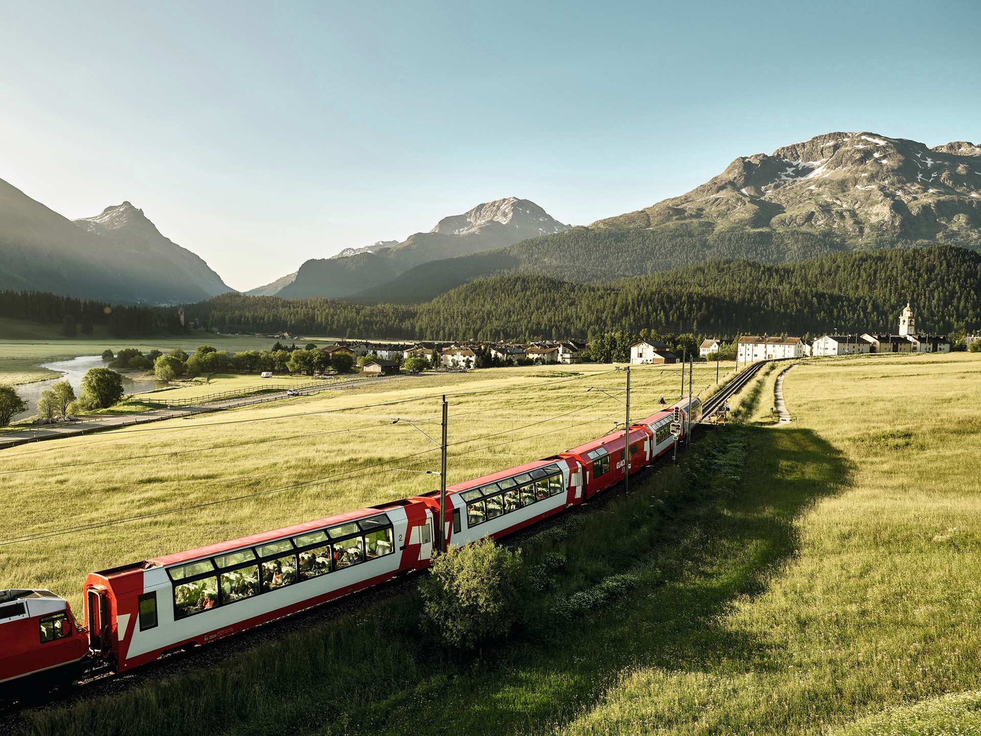 Switzerland Swiss Travel Pass | Glacier train heading through a field in Switzerland