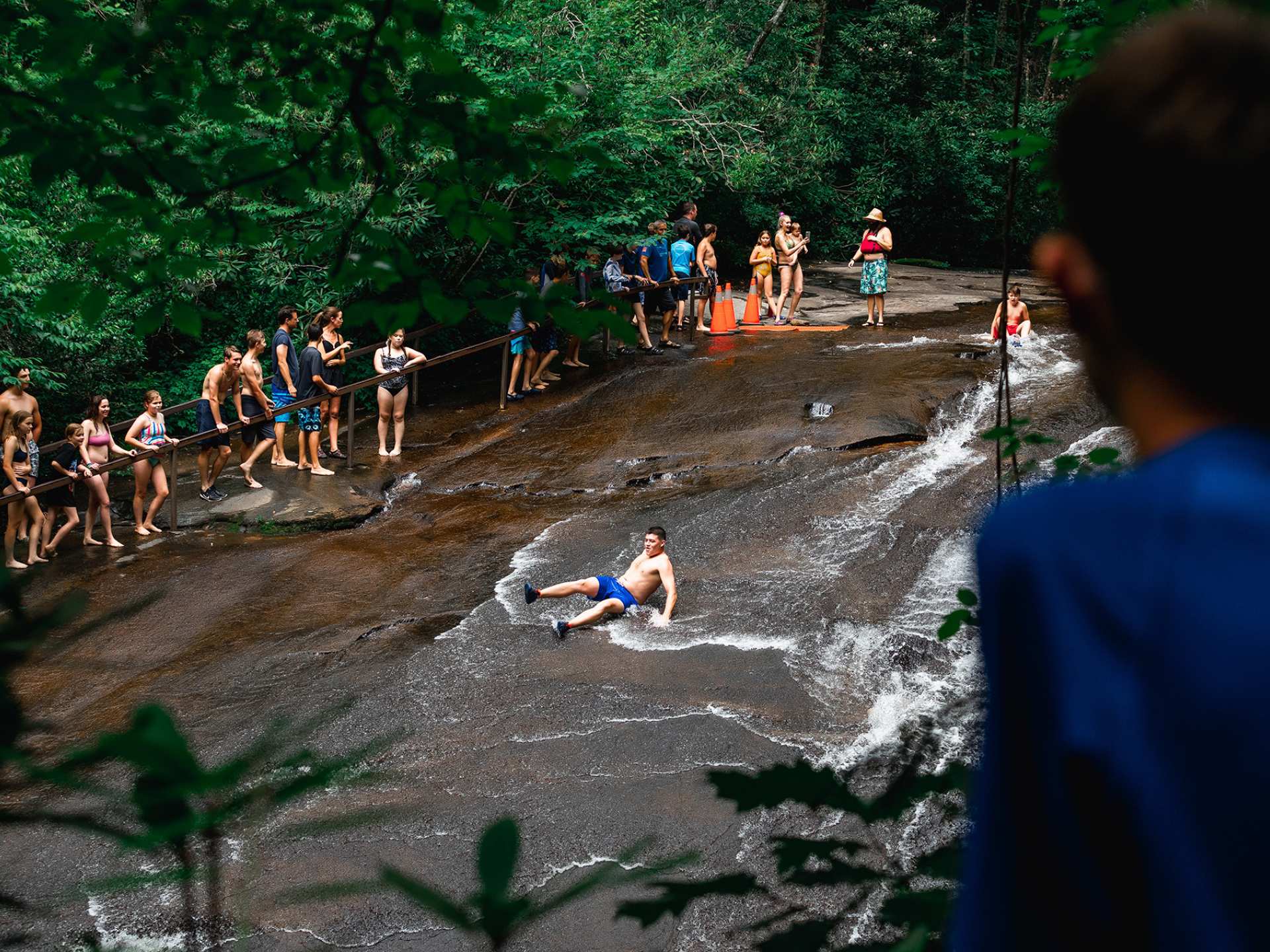 North Carolina | A man sliding down a waterfall in Brevard, North Carolina