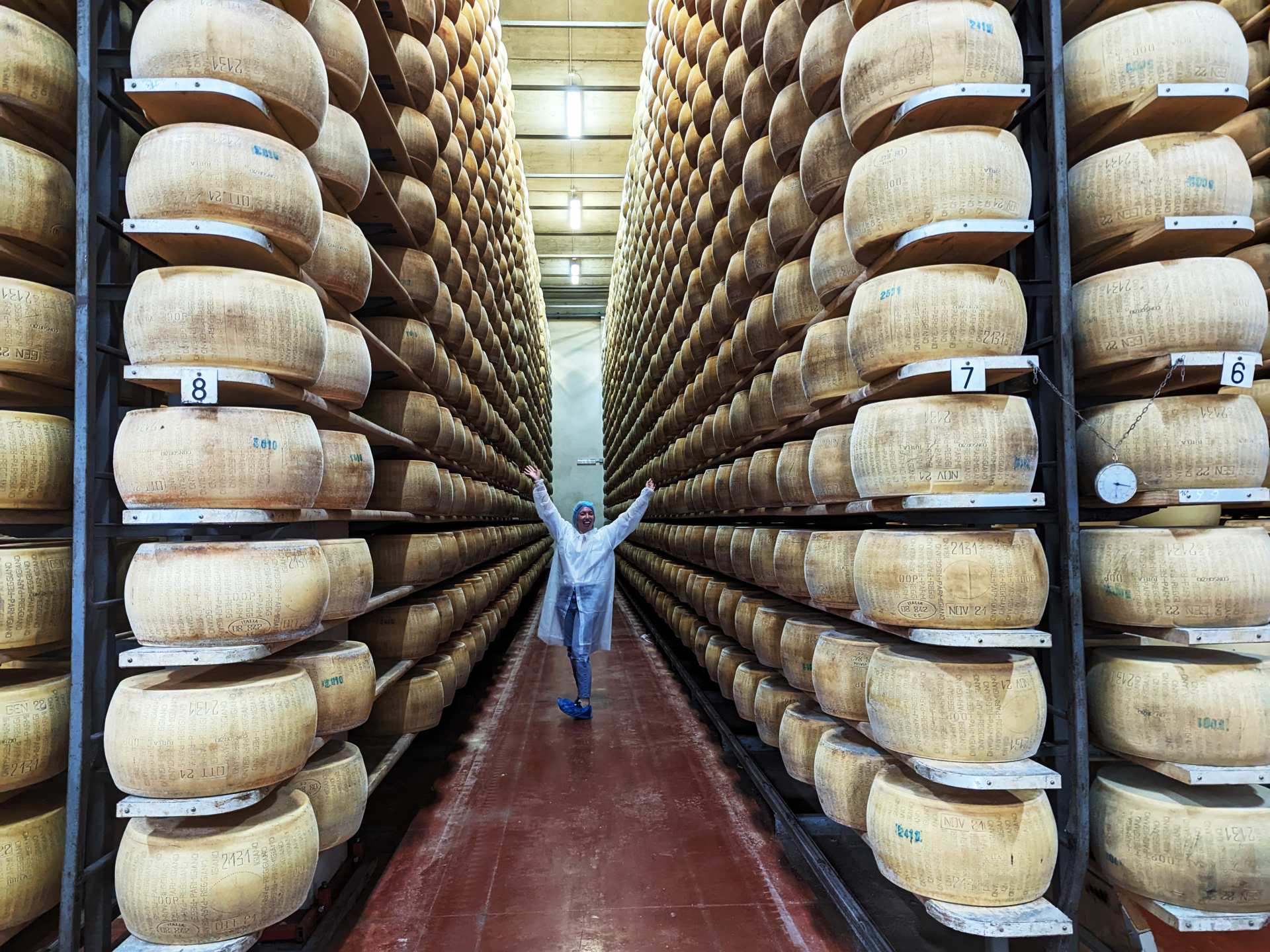 Katie Bridges inside Parmigiano Reggiano Caseificio in Parma, Italy