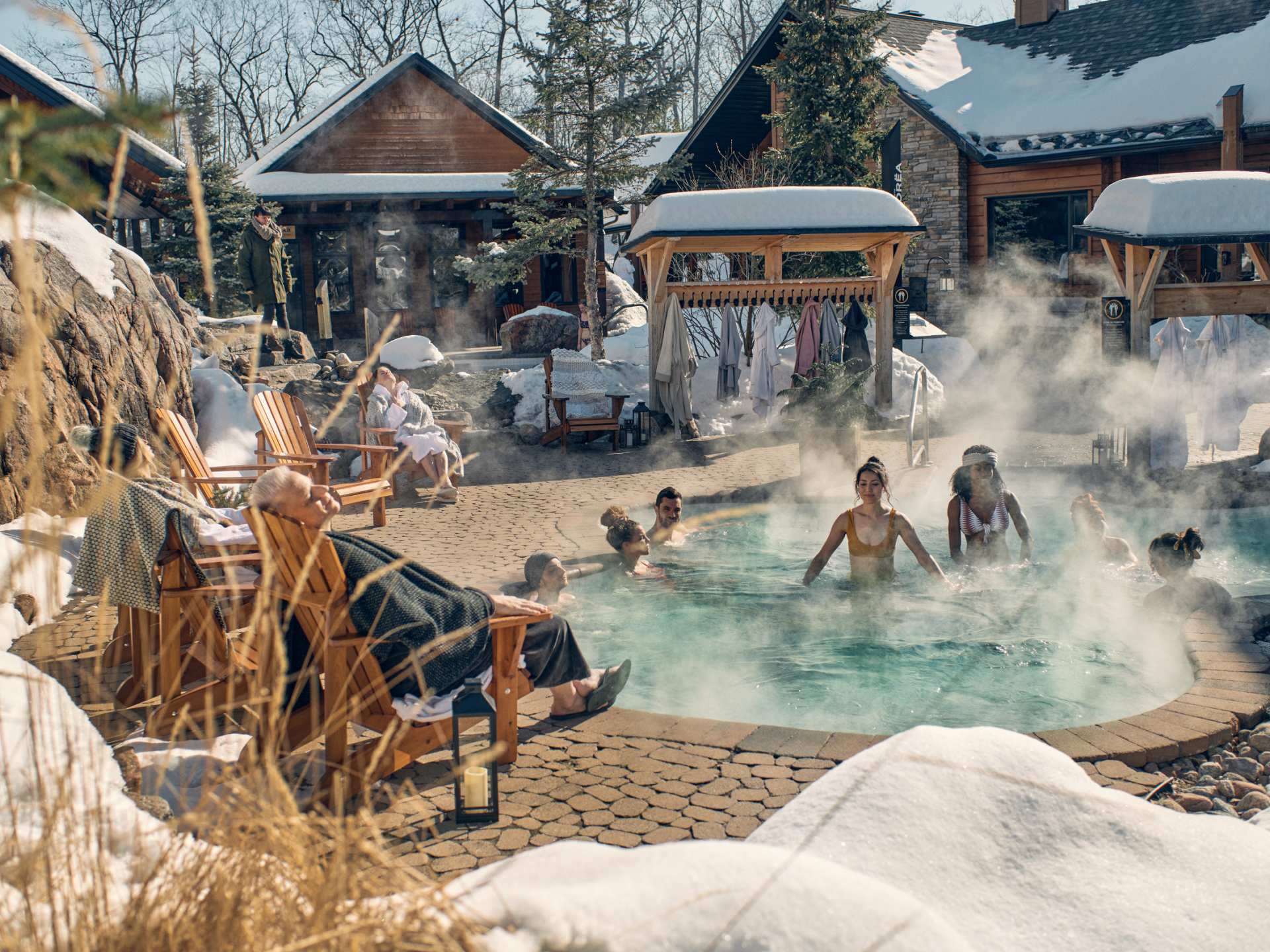 Quebec spas | Guests sitting in the heated pool at Nordik Spa-Nature
