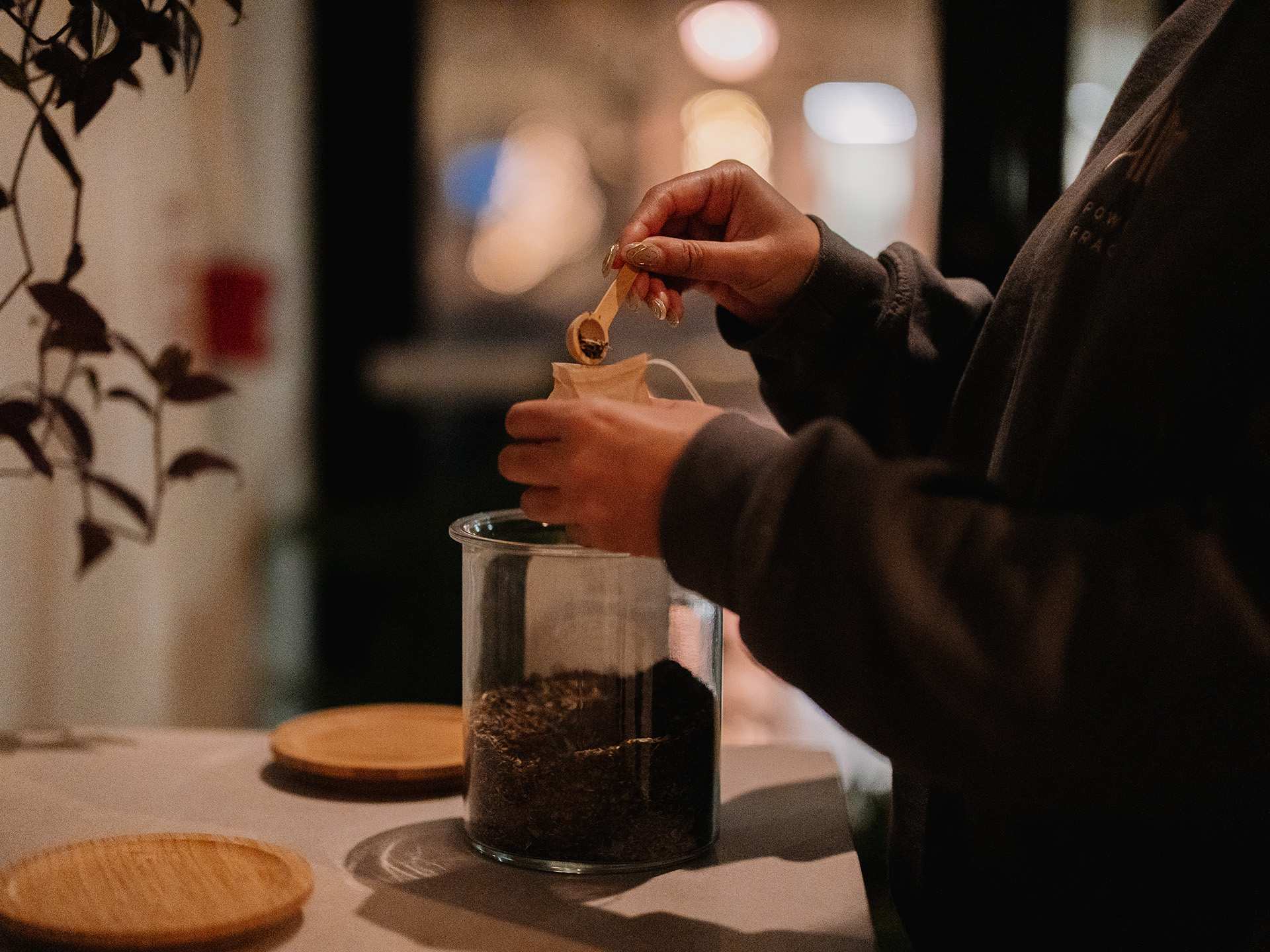 Alter cold plunge and sauna in Toronto | A person filling a tea bag in Alter's tea lounge