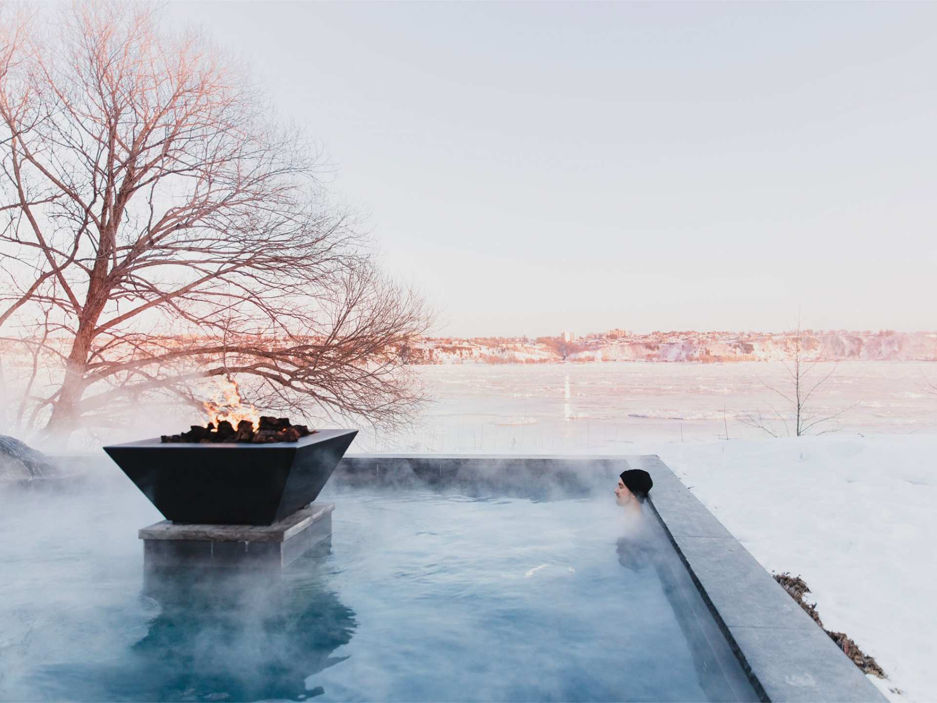 Québec Nordic spa | A person sitting in a thermal bath at Strøm Nordic Spa — Old Québec