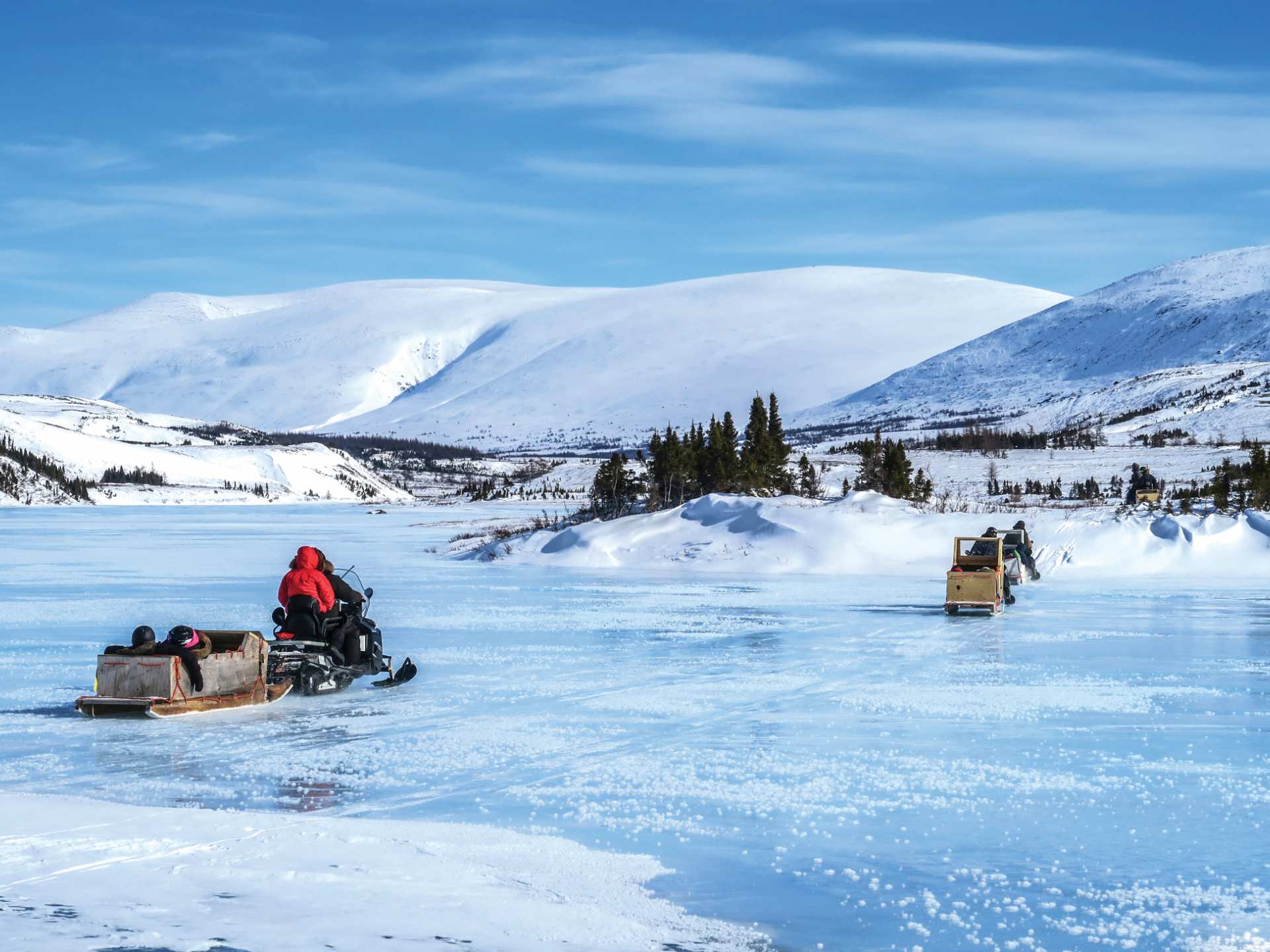 Nunavik | Visitors travel across a frozen lake in Kuururjuaq National Park in Nunavik