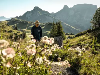 Switzerland Swiss Travel Pass | Man walking through an herb garden at Schynige Platte