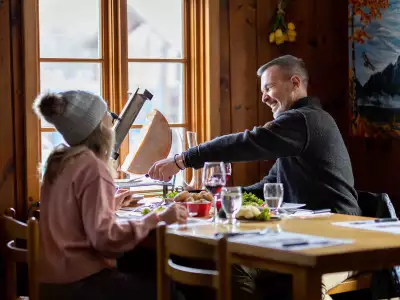 Mont Tremblant activities | Two people enjoying raclette in Mont Tremblant
