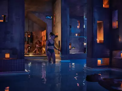 Quebec spas | A woman walking into the Kalla pool at Nordik Spa-Nature