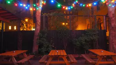 Picnic benches in the courtyard of Lidkoeb cocktail bar in Copenhagen