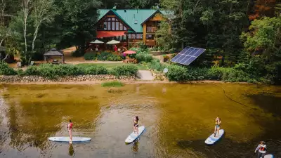 Ontario wellness retreats | Paddle boarders on the lake behind Northern Edge Algonquin wellness retreat