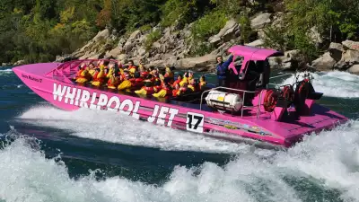 A boat with people wearing life jackets on the Niagara river rapids