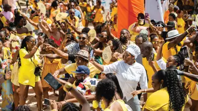 Barbados Rum and Food Festival | A sea of people dressed in yellow at the Rise and Rum Breakfast Beach Party