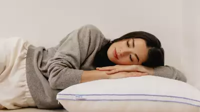 A woman sleeping on The Henrie Adjustable Pillow