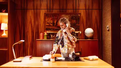 Hotel Zed Tofino | A woman stands at the desk of the 70s office in the lobby