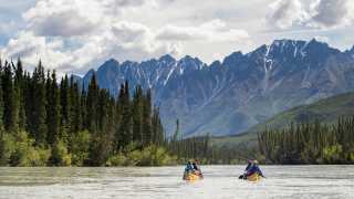 Canoe through canyons on the South Nahanni River