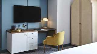 Hotel review: the Kimpton Saint George hotel, Toronto | Desk, chair and TV in a guest room at Kimpton Saint George