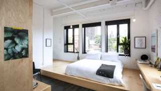 Best hotels Toronto staycation | The Annex Hotel bed on raised platform