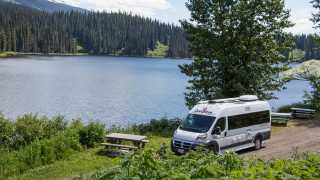 CanaDream: RV rentals in Ontario | A CanaDream Deluxe Van Camper parked beside a lake