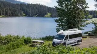 CanaDream: RV rentals in Ontario | A CanaDream Deluxe Van Camper parked beside a lake CanaDream: RV rentals in Ontario | A CanaDream Deluxe Van Camper parked beside a lake