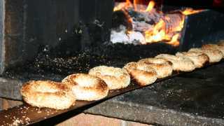 Montreal bagels | Sesame bagels coming out of the oven at St-Viateur bagel shop