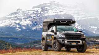 Gears of Travel, Canadian adventure | Chevrolet with canopy camper next to mountains